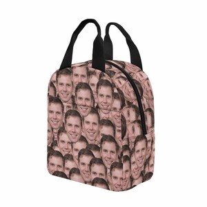 May include: A lunch bag with a black zipper and black handles. The bag is covered in a pattern of a person's face.