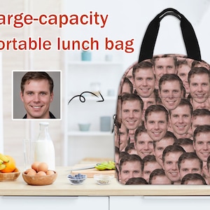 May include: A large-capacity lunch bag with a black handle and a pattern of repeated images of a man's face. The bag is on a white countertop with a bowl of fruit, a bowl of eggs, and a glass of milk in the background.