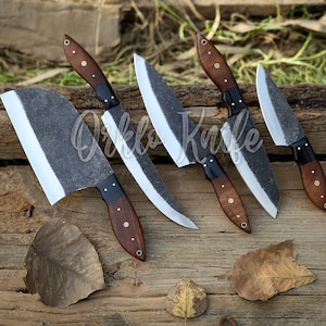 May include: A collection of five handcrafted knives with dark, textured blades and wooden handles. The handles are a rich brown with black accents. The knives are arranged on a rustic wooden surface, showcasing their unique design.
