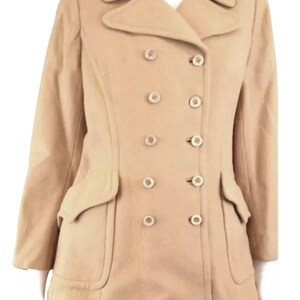 May include: A double-breasted tan wool peacoat with a notched collar and large flap pockets.