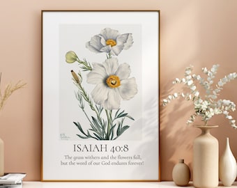 May include: A framed print with a white background featuring a botanical illustration of white flowers with yellow centres. The print includes the text "ISAIAH 40:8" and the quote "The grass withers and the flowers fall, but the word of our God endures forever!"