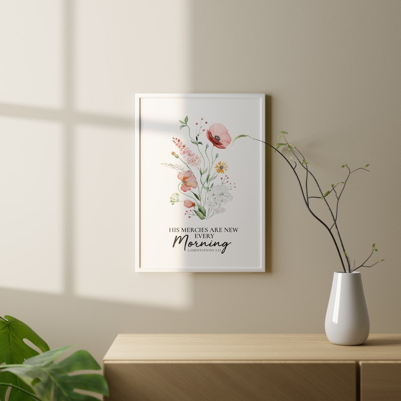 May include: A framed watercolour print with a floral design and the text "His mercies are new every morning. Lamentations 3:23".