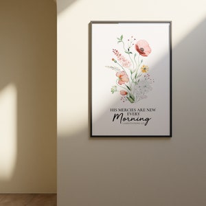 May include: A framed watercolour print featuring a floral bouquet of pink, white and yellow flowers. The text reads "His mercies are new every morning" with the scripture reference "Lamentations 3:23".