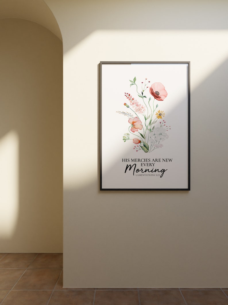 May include: A framed watercolour print featuring a floral bouquet of pink, white and yellow flowers. The text reads "His mercies are new every morning" with the scripture reference "Lamentations 3:23".