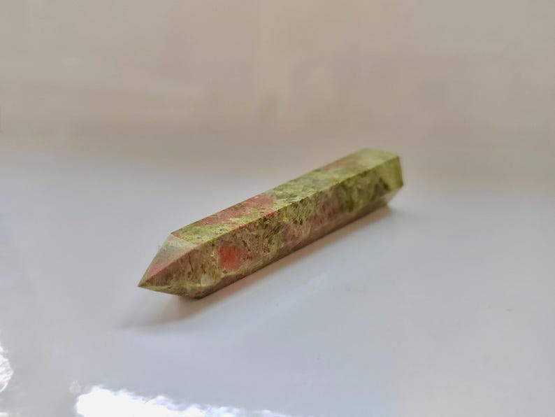 May include: A set of three ceramic mugs with a speckled, matte finish. Each mug features a different color: light blue, cream, and gray. The mugs have a simple, modern design with a rounded shape and a comfortable handle.