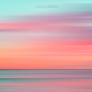 May include: A blurred abstract image of a pink and blue sunset over a calm ocean. The colors are soft and pastel, creating a serene and tranquil atmosphere.