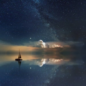 May include: A sailboat with white sails is silhouetted against a dark blue sky with a bright, starry Milky Way. The water is calm and reflects the stars and clouds.