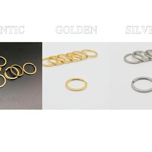 May include: A set of key rings in three finishes: antique gold, golden, and silver. The antique gold key rings are stacked on a dark surface, while the golden and silver key rings are on a white surface.