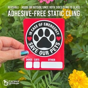 May include: A red, rectangular static cling sticker with the text "IN CASE OF EMERGENCY SAVE OUR PETS" around a paw print. The sticker also has spaces for "DOGS", "CATS", and "OTHER" information. The text "REUSABLE - INSIDE OR OUTSIDE SINCE BOTH SIDES CLING TO GLASS" is at the top.