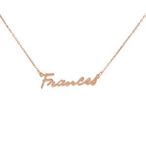 May include: A delicate gold necklace with the name "Frances" written in a cursive script.