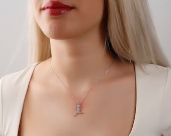 May include: A silver necklace with a pendant shaped like a running person.