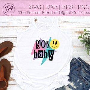 May include: White tank top with a graphic design of a smiley face and the text "90's baby" in a retro style with colorful geometric shapes.