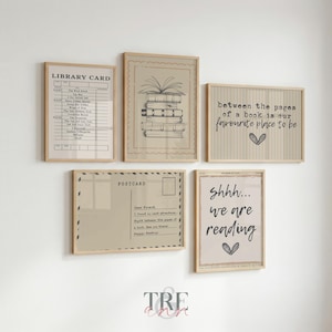 May include: A set of five framed wall art prints with light wood frames. The prints feature a library card, a stack of books, a postcard design, and text that reads "between the pages of a book is our favourite place to be" and "shhh... we are reading".