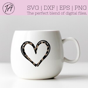 May include: White ceramic mug with a black outline of a heart filled with a leopard print pattern.