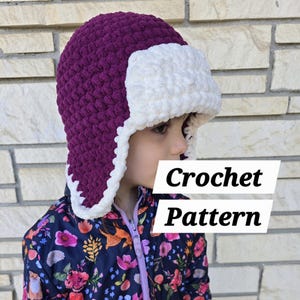 May include: Purple and white crochet hat with ear flaps. Crochet Pattern.