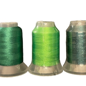 May include: Five spools of thread in different colors: blue, green, lime green, teal, and purple.