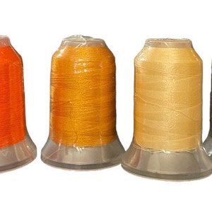 May include: Seven spools of thread in different colors. The spools are arranged in a row from left to right: dark brown, orange, gold, beige, brown, and blue.