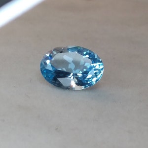 Brazilian topaz.  Fine dark sky blue oval.  10.24ct. Faceted loose gemstone