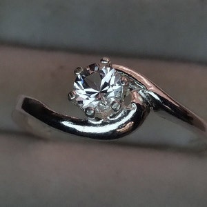 4mm danburite solitaire silver ring.  Size 7. Very beautiful, bright and well cut clear gemstone.