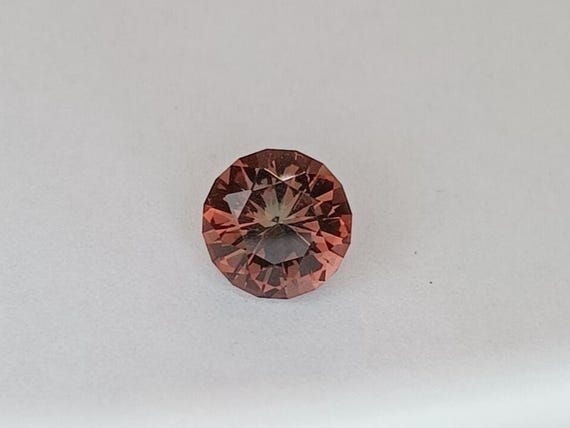 Oregon Sunstone.  8mm. Custom cut in Colorado.  This gem is a bit on the darker side.  Multi colored gemstone.