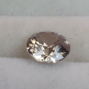 5.5mm zircon.  Light brown to gray Nigerian zircon.  Faceted loose gemstone