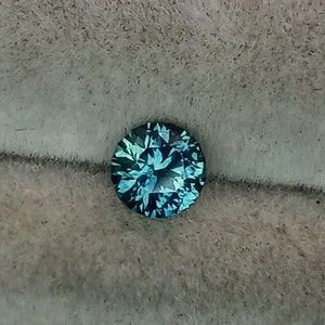 Montana sapphire.  4.75mm round. Teal color. Gorgeous sapphire.  Custom faceted in Colorado.  Faceted loose.