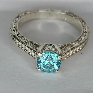 Blue zircon silver ring.  Beautiful setting and gorgeous gemstone.  6mm Cambodian zircon.  Ring size 7