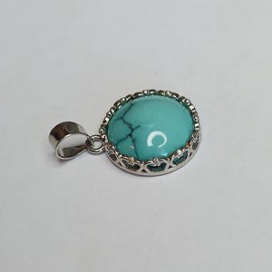Turquoise pendant.  Sterling silver setting.  12mm round turquoise.