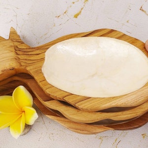 May include: Three wooden pineapple-shaped serving dishes with a white mother-of-pearl bowl insert. The dishes are stacked on top of each other.