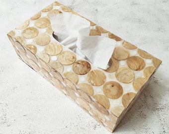 May include: A rectangular tissue box cover made of wood with a circular pattern. The cover is made of light brown wood with white circles.