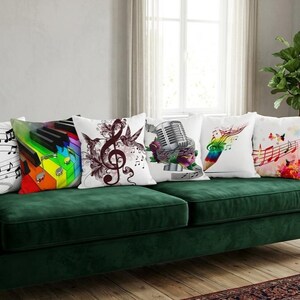 May include: A green velvet sofa with five decorative throw pillows. The pillows feature musical themes, including musical notes, a piano keyboard, a treble clef, a microphone, and colorful musical notes with butterflies.