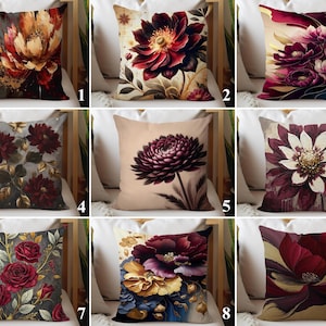 Pode incluir: Uma coleção de almofadas decorativas com desenhos florais. As almofadas apresentam desenhos florais artísticos em tons de vermelho, bordô, dourado e creme. Cada almofada tem um padrão floral único, oferecendo uma variedade de estilos.