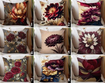 May include: A collection of decorative throw pillows featuring floral designs. The pillows showcase various artistic renderings of flowers in shades of red, burgundy, gold, and cream. Each pillow has a unique floral pattern, offering a range of styles.