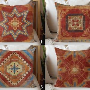 May include: Four square throw cushions featuring distinct geometric patterns in shades of rust orange, deep red, and muted blue. Each cushion displays a unique symmetrical design with intricate lines, star shapes, and floral-inspired motifs.