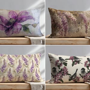 May include: Four rectangular throw pillows featuring distinct botanical and avian prints. The first shows a large purple flower, the second displays hanging wisteria, the third features a lavender pattern, and the fourth depicts birds on pink blossoms.