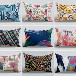 May include: Nine decorative cushions with diverse patterns. Designs include geometric shapes in blue and white, floral and abstract art in pink and green, and a geometric pattern in yellow, black, and white. Other cushions feature owls, flowers, and tropical themes.