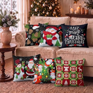 May include: A set of six square throw pillows featuring Christmas themes. Designs include a snowman with a red plaid scarf, a black pillow with the text Have yourself a merry Christmas, a Santa Claus scene, and a red and green checkered pattern.