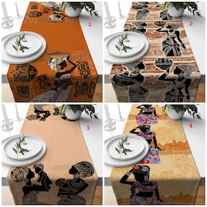 Puede incluir: Cuatro caminos de mesa diferentes con diseños de inspiración africana. Cada camino de mesa presenta un patrón diferente con siluetas negras de mujeres y formas geométricas sobre un fondo beige o naranja.