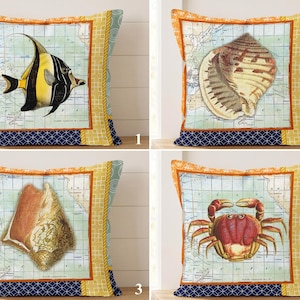 May include: Four square scatter cushions featuring nautical themes. Each cushion displays a vintage map background with a central illustration of a fish, two different seashells, or a crab. The borders are orange, yellow, and dark blue patterns.
