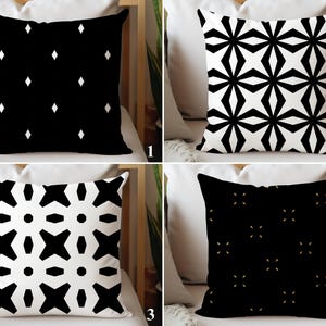 May include: Four decorative throw pillows with geometric patterns. The pillows feature black and white designs, including diamonds, starbursts, and cross-like shapes. The pillows are square and appear to be made of a soft fabric.