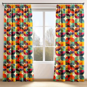 May include: A pair of curtains featuring a geometric design in shades of red, orange, yellow, green, blue, and purple. The pattern is made up of circles, squares, and rectangles.
