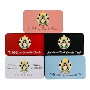 May include: Five different oracle decks with colorful backgrounds and a woman meditating in a circle of moons. The decks are titled "Self-Love Oracle Deck", "Triggers Oracle Deck", "Shadow-Work Oracle Deck", "Divine Feminine Oracle Deck", and "Divine Masculine Oracle Deck".