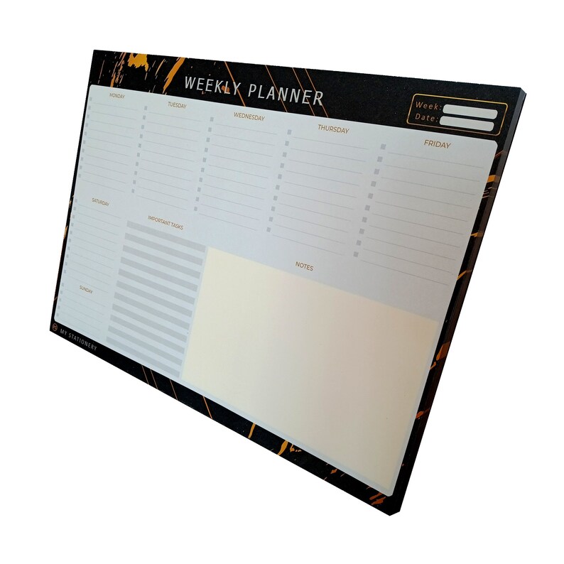 May include: Black and gold weekly planner with a marble-like design. The planner has sections for Monday through Friday, Saturday, Sunday, important tasks, and notes.