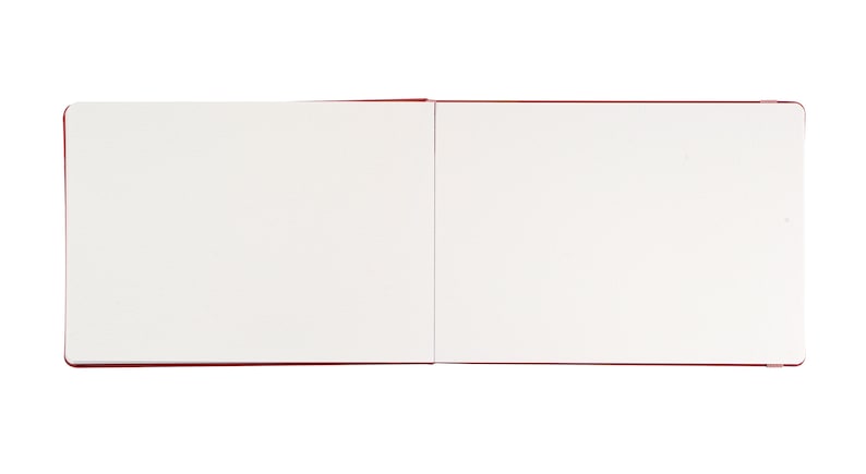 May include: A blank, white sketchbook with a red cover. The book is open to a fresh, blank page.