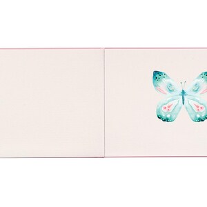 May include: A blank white card with a pink border. The card is open to reveal a watercolour illustration of a light blue butterfly with pink accents.