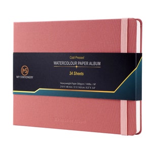 May include: A pink watercolor paper album with a black label that reads "Cold Pressed Watercolor Paper Album 24 Sheets". The label also includes the dimensions of the paper: 8.3" x 5.8".