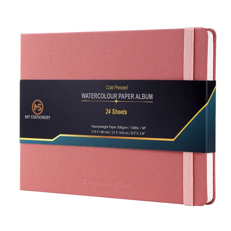 May include: A pink watercolor paper album with a black label that reads "Cold Pressed Watercolor Paper Album 24 Sheets". The label also includes the dimensions of the paper: 8.3" x 5.8".