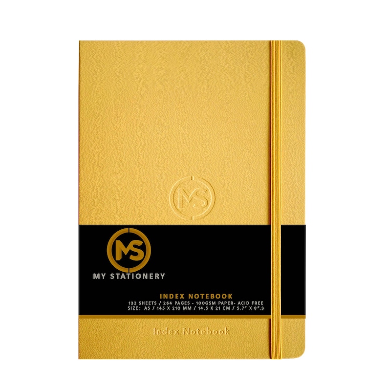 May include: A gold-colored index notebook with a matching elastic band closure. The notebook features the text "MY STATIONERY" and "INDEX NOTEBOOK" on a black band. The notebook is A5 size, measuring 5.7" x 8.3".