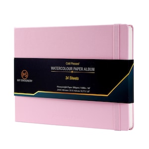 May include: A pink watercolor paper album with a black label that reads "Cold Pressed Watercolor Paper Album 24 Sheets". The label also includes the dimensions of the paper: 8.3" x 5.8".