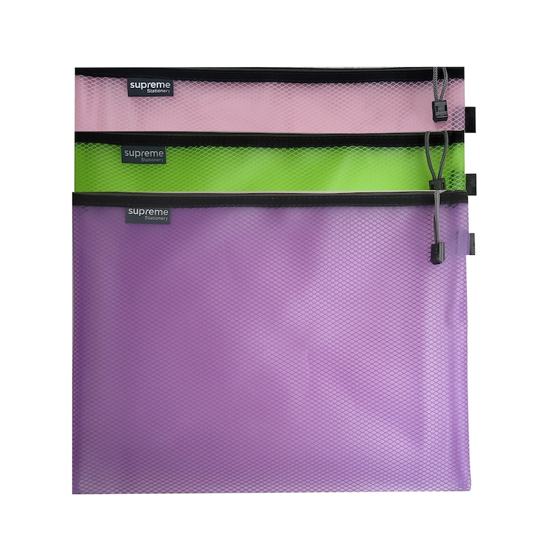 May include: Three mesh zipper pouches in pink, green, and purple. Each pouch has a black zipper and a black pull cord. The top of each pouch has a small label that reads "supreme stationery".